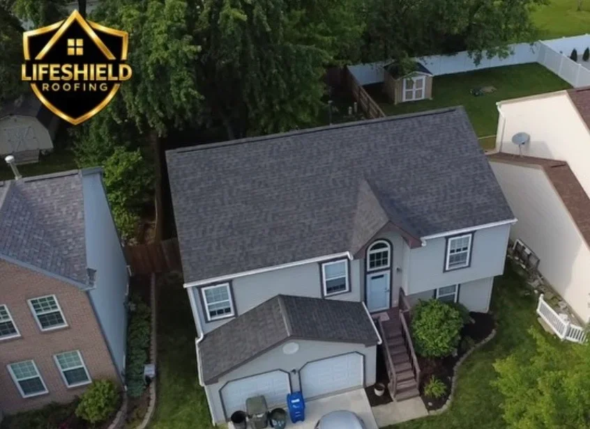 Two-story home with new charcoal gray asphalt shingle roof and matching garage roof